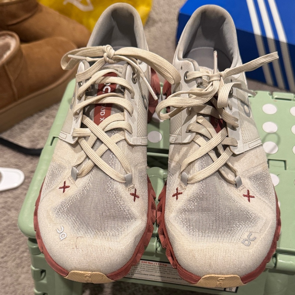 On Running Cream and Red Athletic Shoes